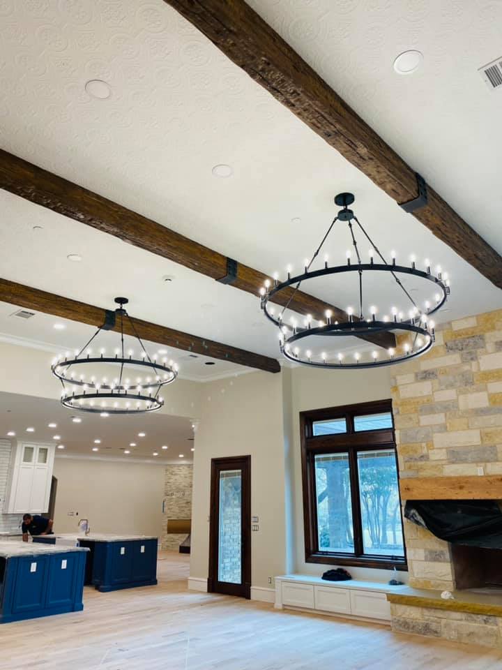 Great room with twin chandeliers and exposed beams